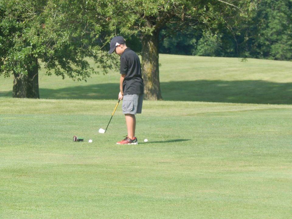 A golfer on one of the open, tree-lined fairways at Twin Lakes