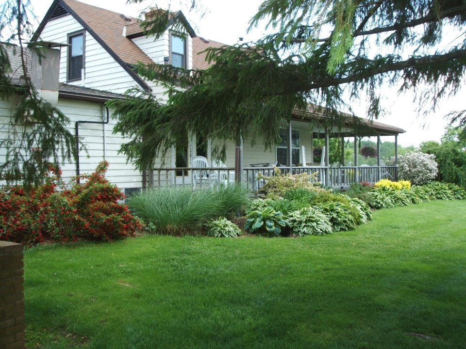 The house on the course at Twin Lakes, with a wraparound porch and gardens